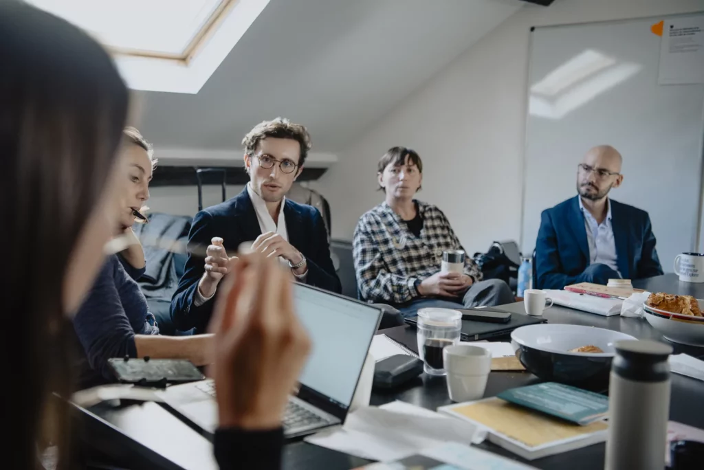 Session de travail du Programme Médianes : quatre personnes autour d’une table.